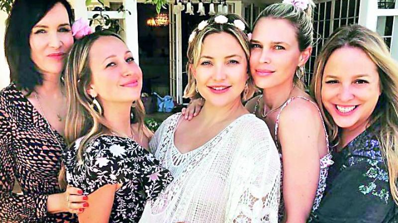 The star shared an adorable picture of herself with her friends on Instagram, in a white lace dress, captioning it,