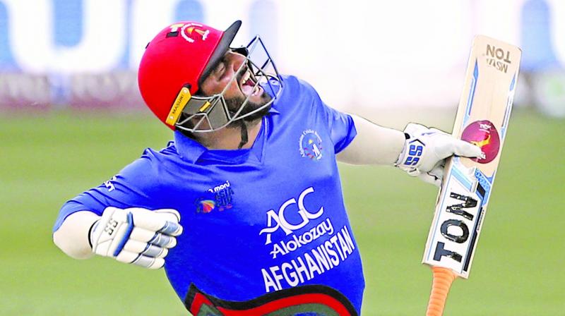 Mohammad Shahzad celebrates his century against India. (Photo: AP)