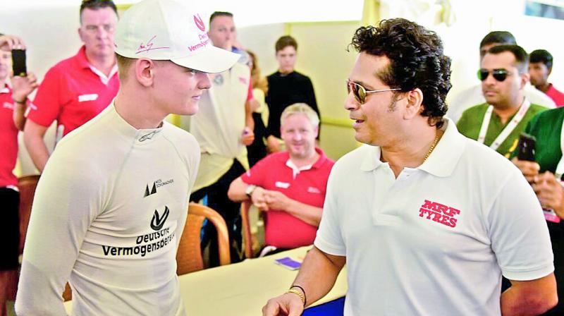Sachin Tendulkar interacts with Mick Schumacher, son of F1 legend Michael Schumacher, at the Madras Motor Racing Track on Sunday.