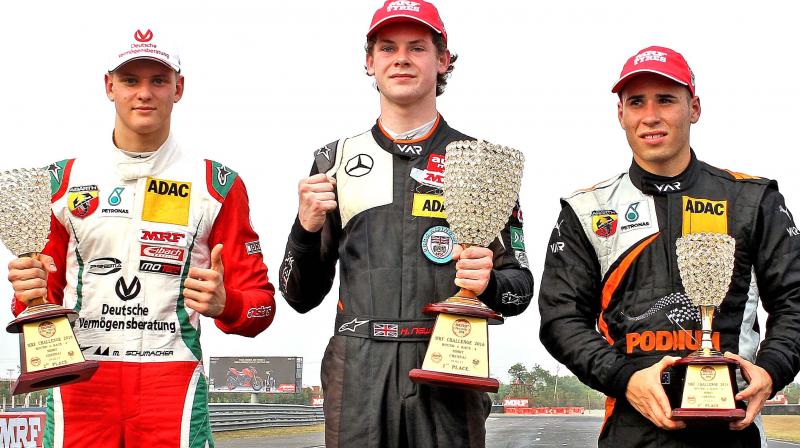 MRF Challenge champion Harrison Newey is flanked by Joey Mawson (right) and Mick Schumacher.