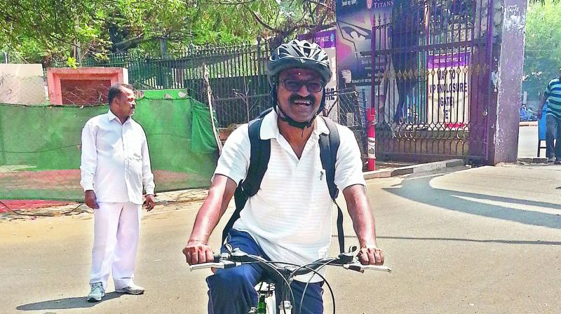Sports Authority of Telangana State Vice-chairman and Managing Director A. Dinakar Babu poses at the Lal Bahadur Stadium after riding a bicycle from his home in Sainikpuri on Thursday.