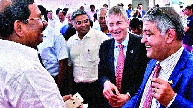 Known for his warmth and friendly access, Minister K. Pandiarajan is seen exchanging his visiting cards with the audience comprising senior Rotarians and entrepreneurs at the launch of the vocational excellence centre set up by the Rotary Club of Madras East at Thoraipakkam on Saturday. 	 DC