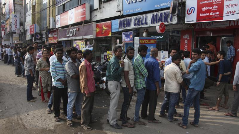 People stand in a queue to withdraw currency from an ATM in Hyderabad (Photo: AP)