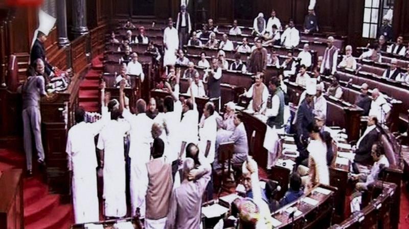 Opposition members protest in the well of Rajya Sabha during the winter session of Parliament in New Delhi. (Photo: PTI)