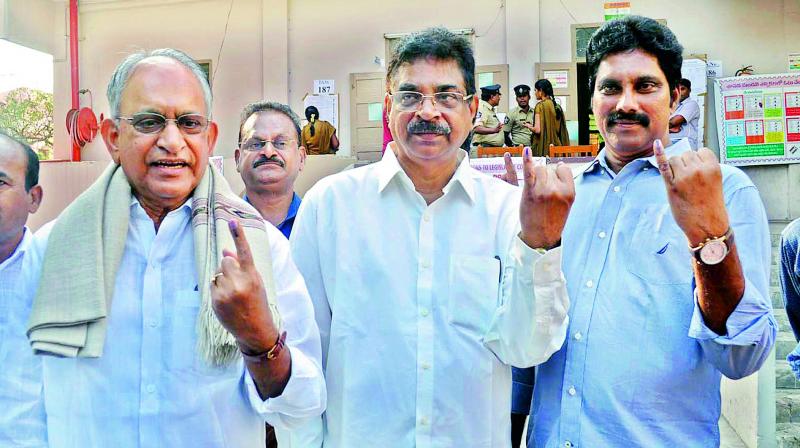 Vizag MP K. Haribabu, MLC M.V.V.S. Murthi display the ink mark on their fingers after casting their vote at the Graduates MLC polls in Visakhapatnam on Thursday.