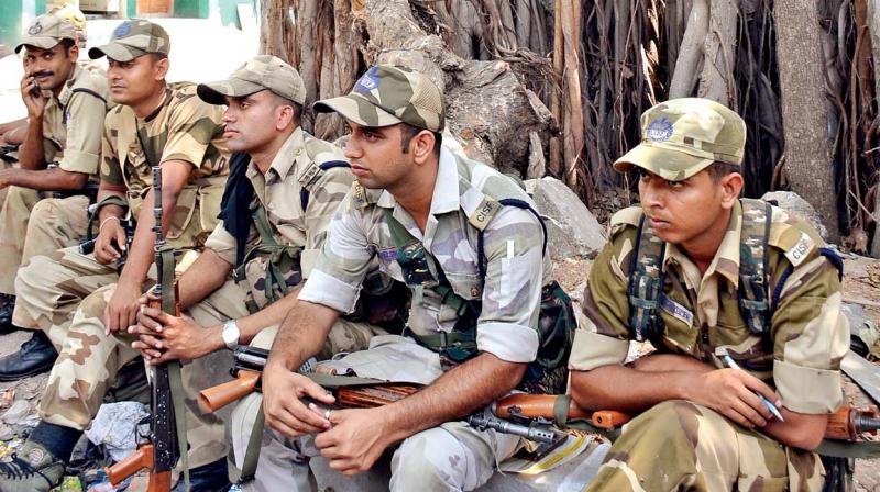 CISF personnel, after knowing about the cancelled elections in RK Nagar, relax under a banyan tree at New Washermanpet. (Photo: DC)