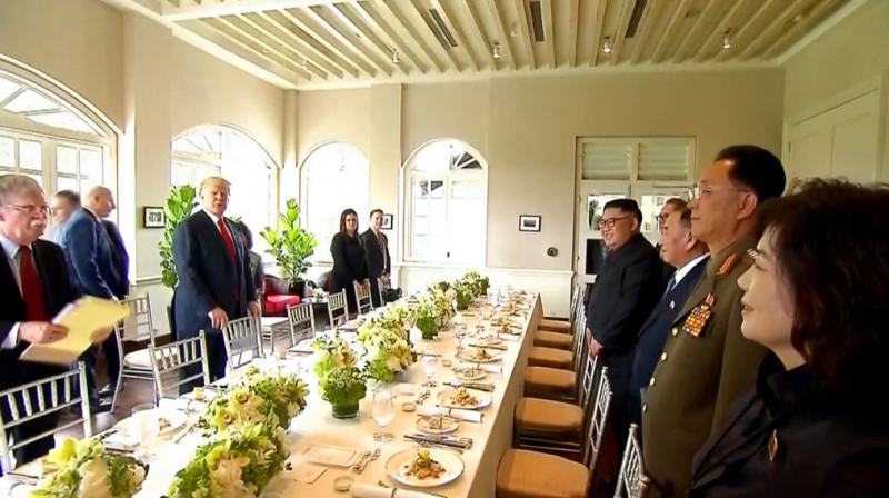 In this image made from video provided by Host Broadcaster Mediacorp Pte Ltd, US President Donald Trump, second from left, and North Korean leader Kim Jong Un, fourth from right, arrive for a working lunch at Capella Hotel in Singapore, Tuesday. (Photo: AP)