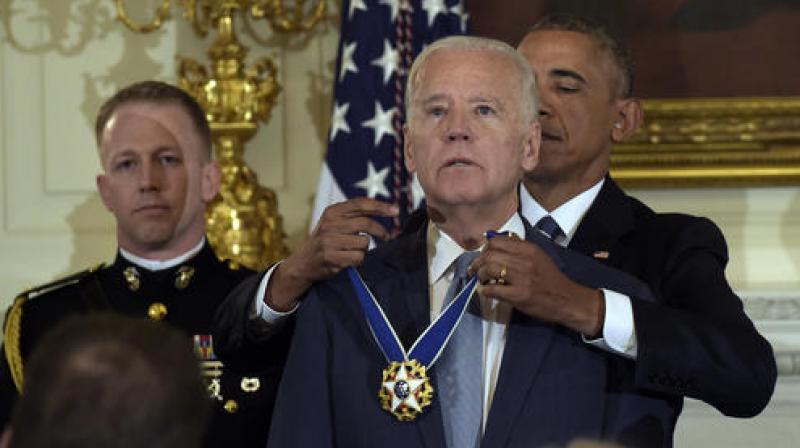 President Barack Obama presents Vice President Joe Biden with the Presidential Medal of Freedom during a ceremony in the State Dining Room of the White House in Washington. (Photo: AP)
