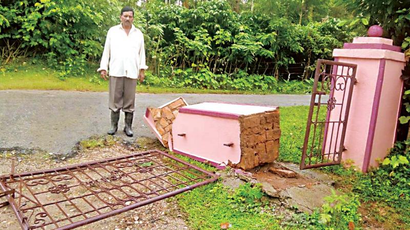 The compound wall which was razed by  jumbos at Talavara village in Mudigere taluk of Chikkamagaluru