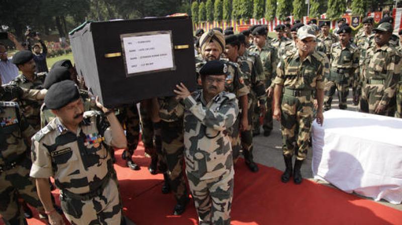 BSF officers carry the coffin of head constable Jitender Kumar Singh, during a wreath-laying ceremony at BSF headquarters in Jammu. (Photo: PTI)