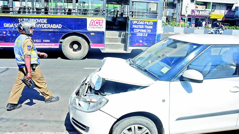 Police inspects a car that rammed into an RTC bus at Tarnaka on Friday.  (Photo: DC)