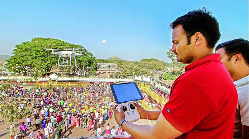 A police personnel uses a drone to survey the crowd at the Sammakka and Saralamma on Friday. (Photo: DC)