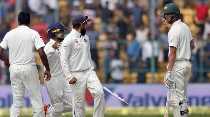 Indias captain Virat Kohli, second right, gestures to Australias Josh Hazlewood, right, as he celebrates with teammates after their win on the fourth day of their second test cricket match in Bangalore, India. (Photo: AP)