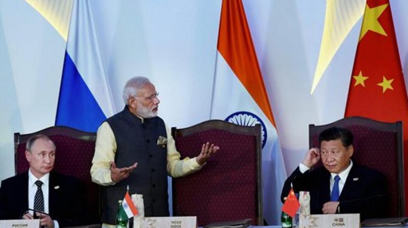 Prime Minister Narendra Modi, Russian President Vladimir Putin and Chinese President Xi Jinping after the press statement during BRICS Summit in Benaulim, Goa. (Photo: PTI)