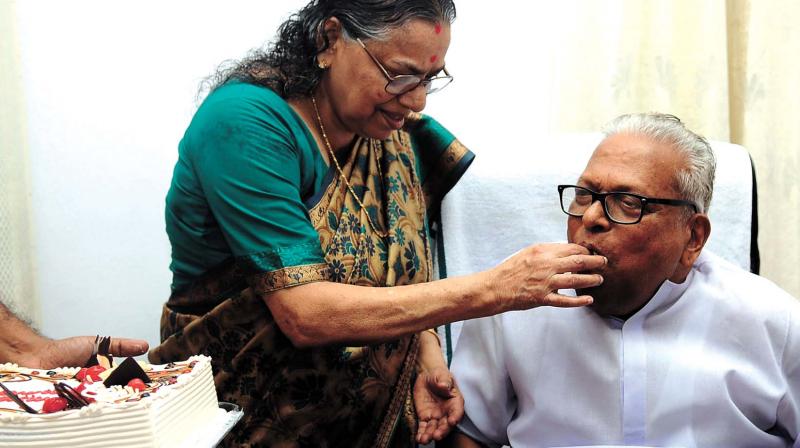 V.S. Achuthanandans wife K. Vasumathy offers him a piece of cake on his 93rd birthday. (Photo:  DECCAN CHRONICLE)