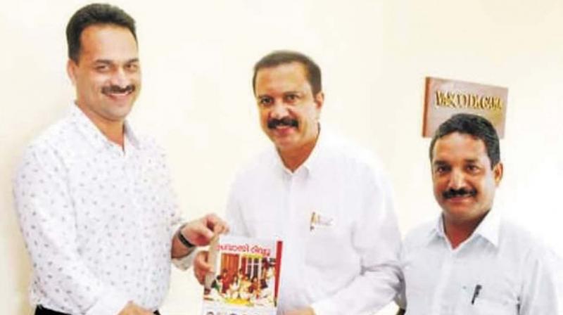 Aster Mims chairman Azad Moopan releasing the Pravasi Review by handing over the first copy to Calicut Chamber of Commerce and Industry secretary A.M. Sherif. Also seen is chief editor PT Nisar.