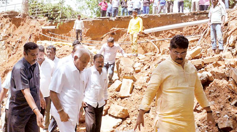 BJP state president B.S. Yeddyurappa and party leader R. Ashok at rain-hit Yediyur Ward in Bengaluru on Wednesday. (Photo: KPN)