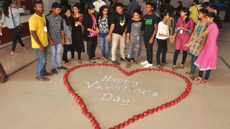 Students of Sacred Heart College, Thevara, celebrate the Valentines Day on the campus by making the symbolic love sign with red coconut shells painted in blazing red.(Photo: SUNOJ NINAN MATHEW)