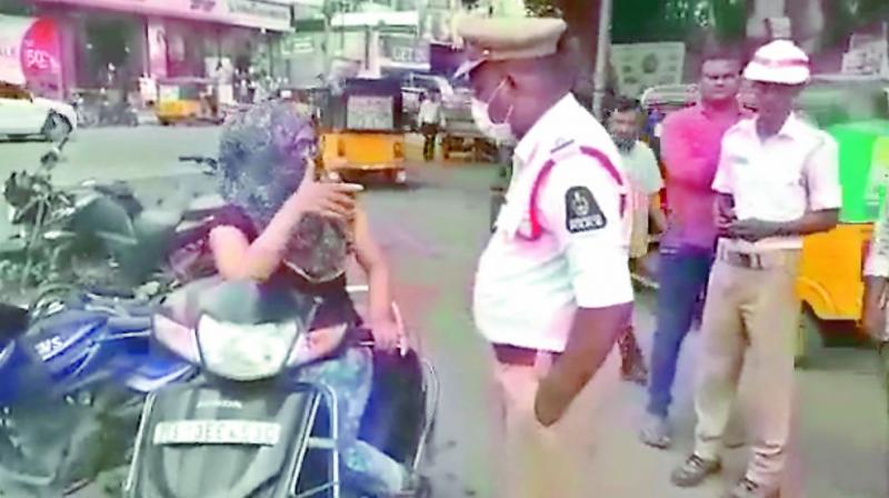 The screengrab of the video which shows the woman abusing a traffic police inspector.   (Image: DC)