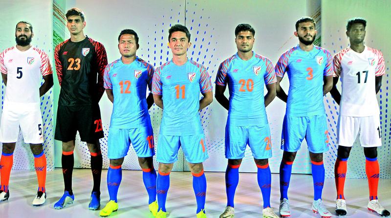 Indian football team captain Sunil Chhetri (centre) is flanked by teammates during the unveiling of the teams new jersey in New Delhi on Wednesday.	 Deccan Chronicle