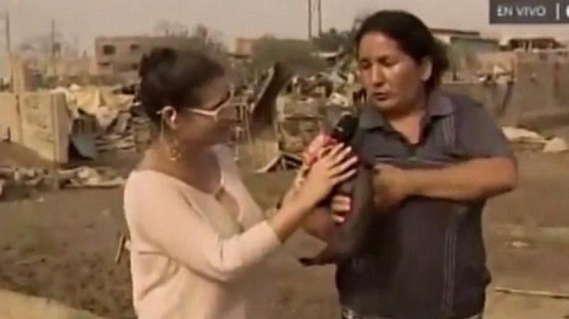 To explain her situation, the woman who was holding a piglet in her hand, whipped out her breast and started feeding the animal. (Photo: YouTube Screengrab)