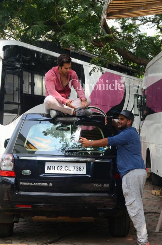 Varun Dhawan rehearses his lines on top of a car on Judwaa 2 sets